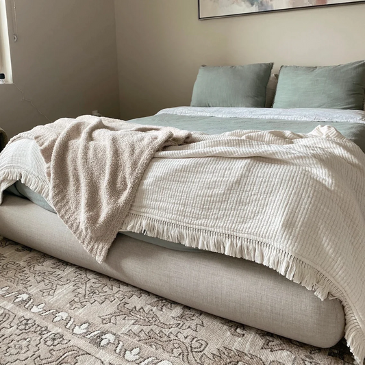 A Luna bed frame from SoftFrame Designs adorned with a cozy blanket