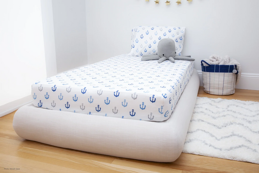 A child's room decorated with anchors and sea creatures and featuring a soft bed frame from SoftFrame Designs