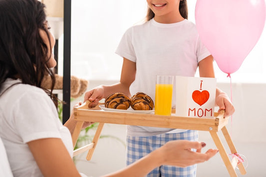 A child giving a Mother’s Day breakfast in bed.