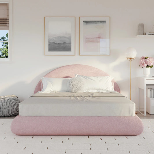 Pink all cushioned bed in a bedroom with white walls and decor