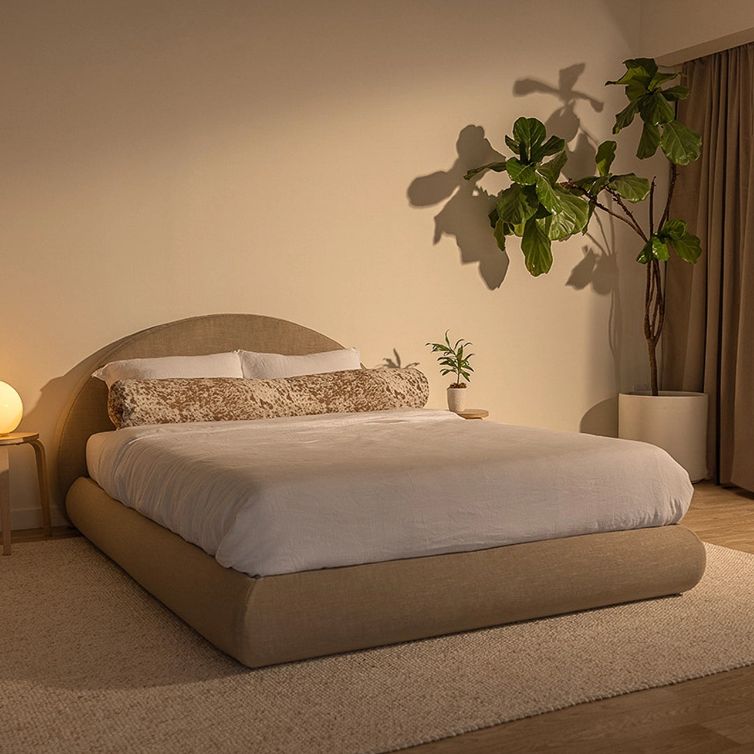 Tan bed frame in a bedroom with plants and warm lighting | Luna Set, Queen, 3/4th, Sahara | SoftFrame Designs