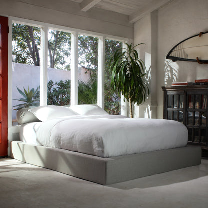 Gray all cushioned bed frame in a beach room