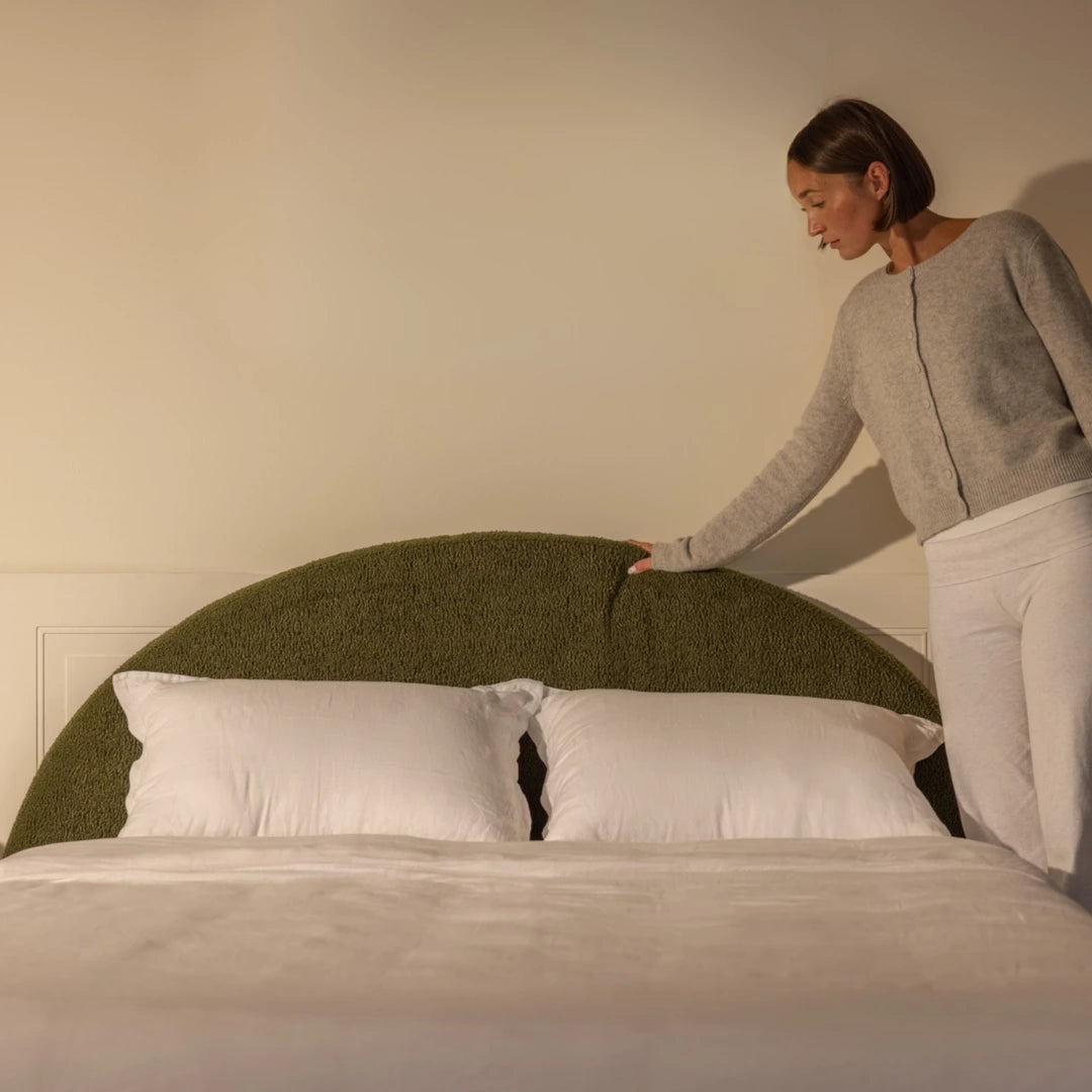 Woman standing beside a dark green bed with white pillows and a dark green headboard | Luna Set in Moss | SoftFrame® Designs