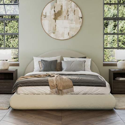 Modern bedroom with a all cushioned bed, side tables, and large windows.