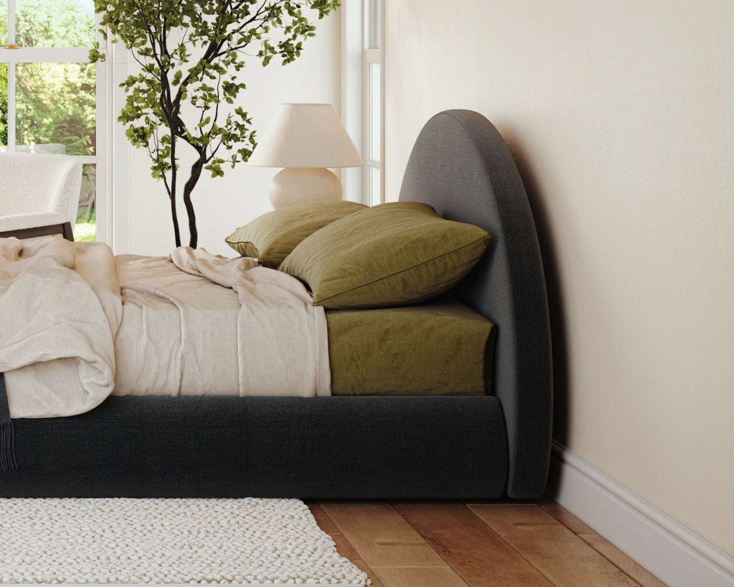 Bedroom with a bed featuring green pillows and a lamp in the corner.