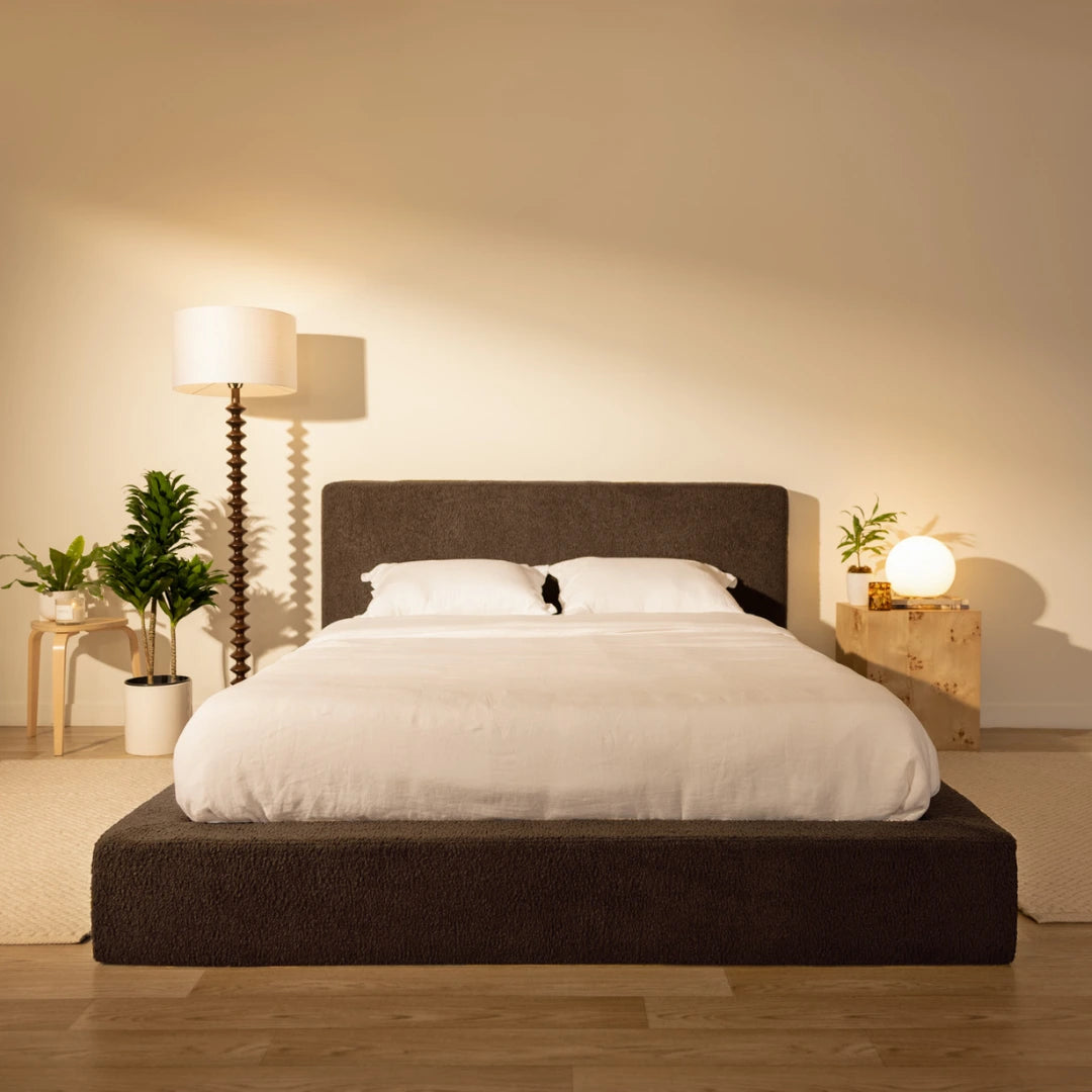 Modern bedroom with a dark brown bed frame, white bedding, and decorative plants | Ultra Bed Set in Chocolate | SoftFrame® Designs