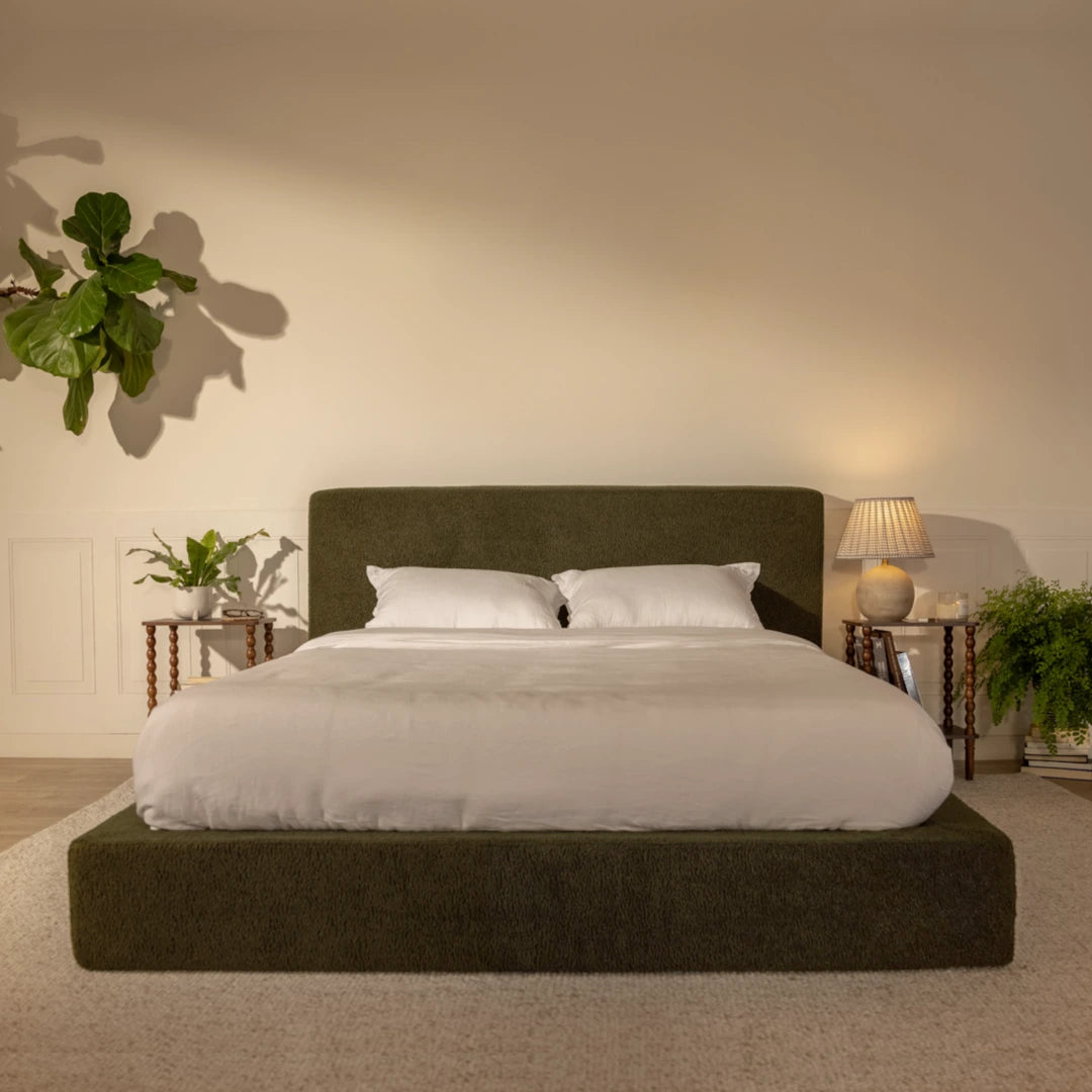 Bedroom with an olive green bed, nightstands, and plants on a neutral background | Ultra Bed Set in Moss | SoftFrame® Designs