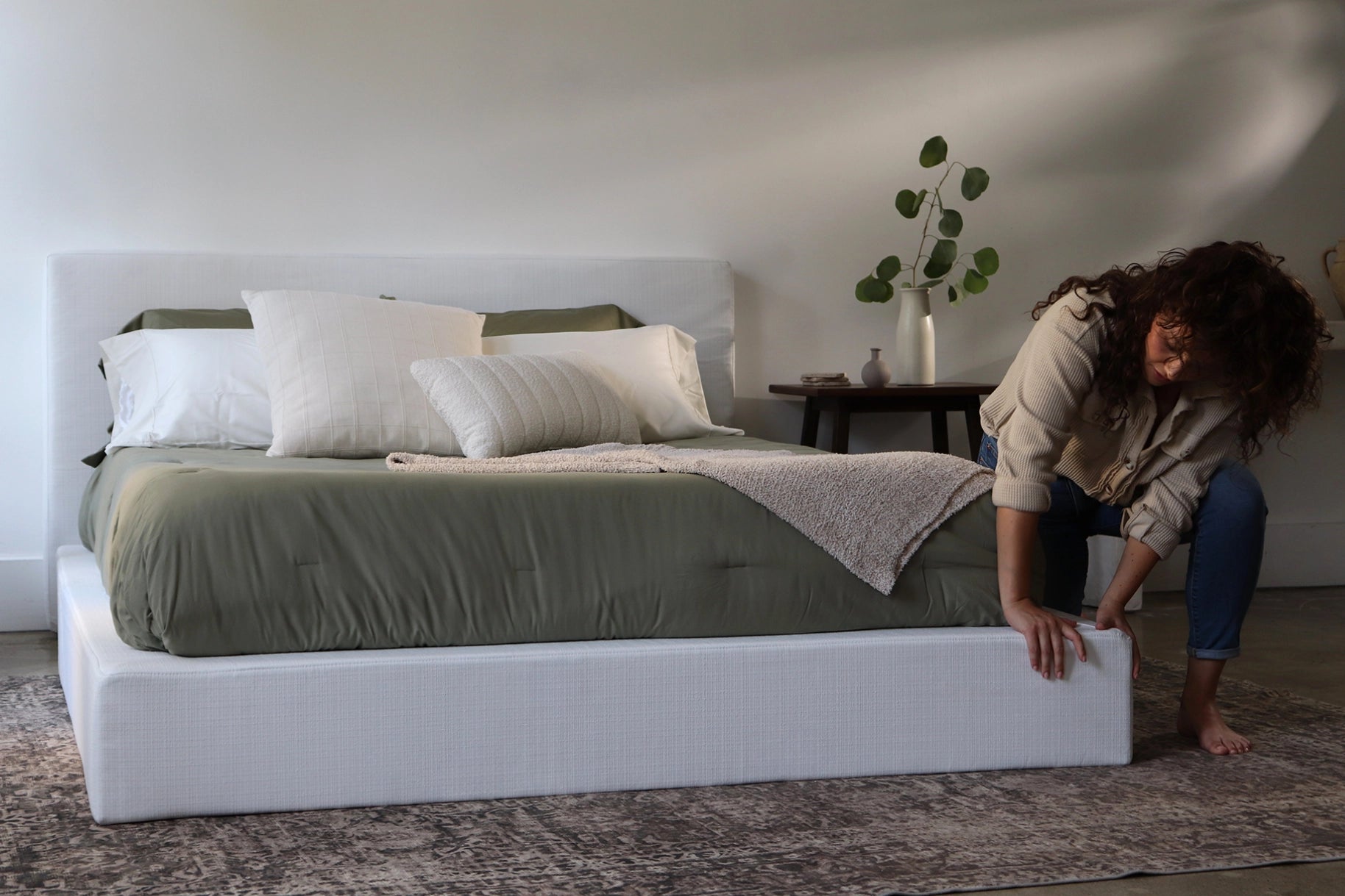Woman Squeezing White Upholstered Bed Frame Set | Ultra Bed Set, Queen Size, White | 3/4 view | SoftFrame Designs