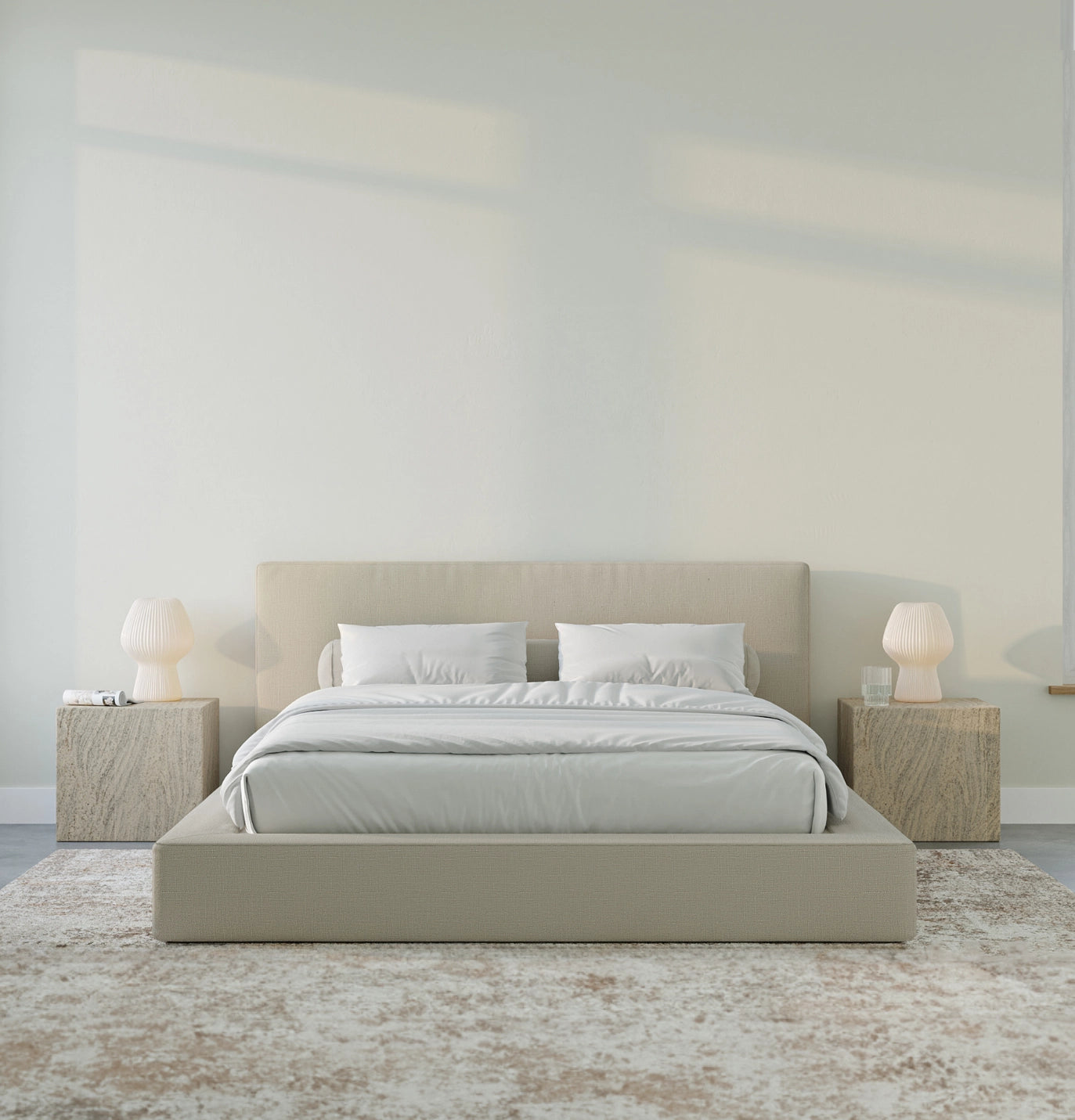 Beige bed with matching headboard and nightstands in a minimalistic bedroom.