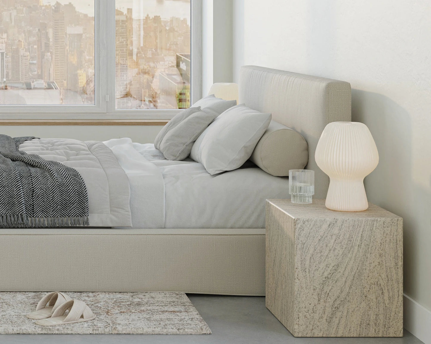 Modern bedroom with a bed, nightstand, and lamp.