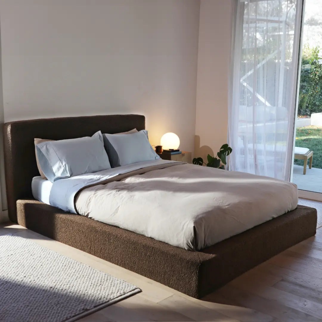 Bedroom with a brown soft upholstered bed frame and headboard, lamps, and decor in a cozy setting | Ultra Bed Set in Chocolate | SoftFrame® Designs
