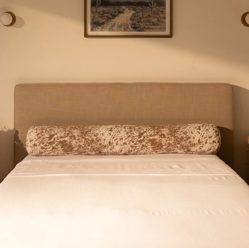 Tan bed frame with a headboard and decorative round pillow in faux palomino fabric | Round Bolster Pillow, Queen, Pony Palomino | SoftFrame Designs