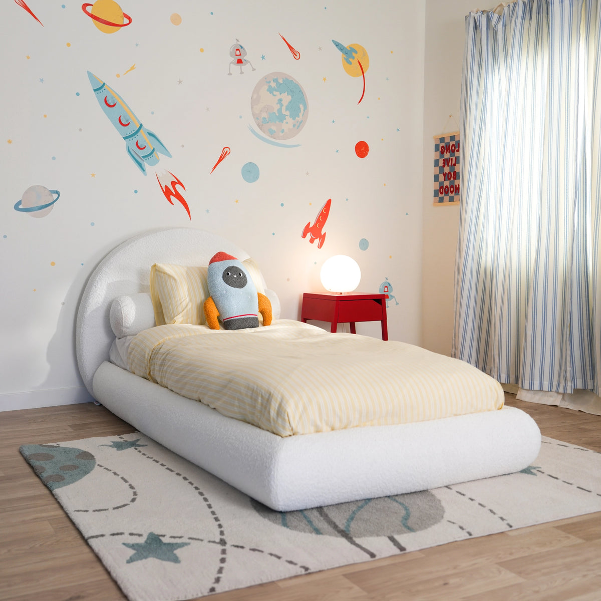 3/4 view of a Boucle white all cushioned bed set from softframe designs in a space decorated room with spaceship wall decal and yellow bed sheets