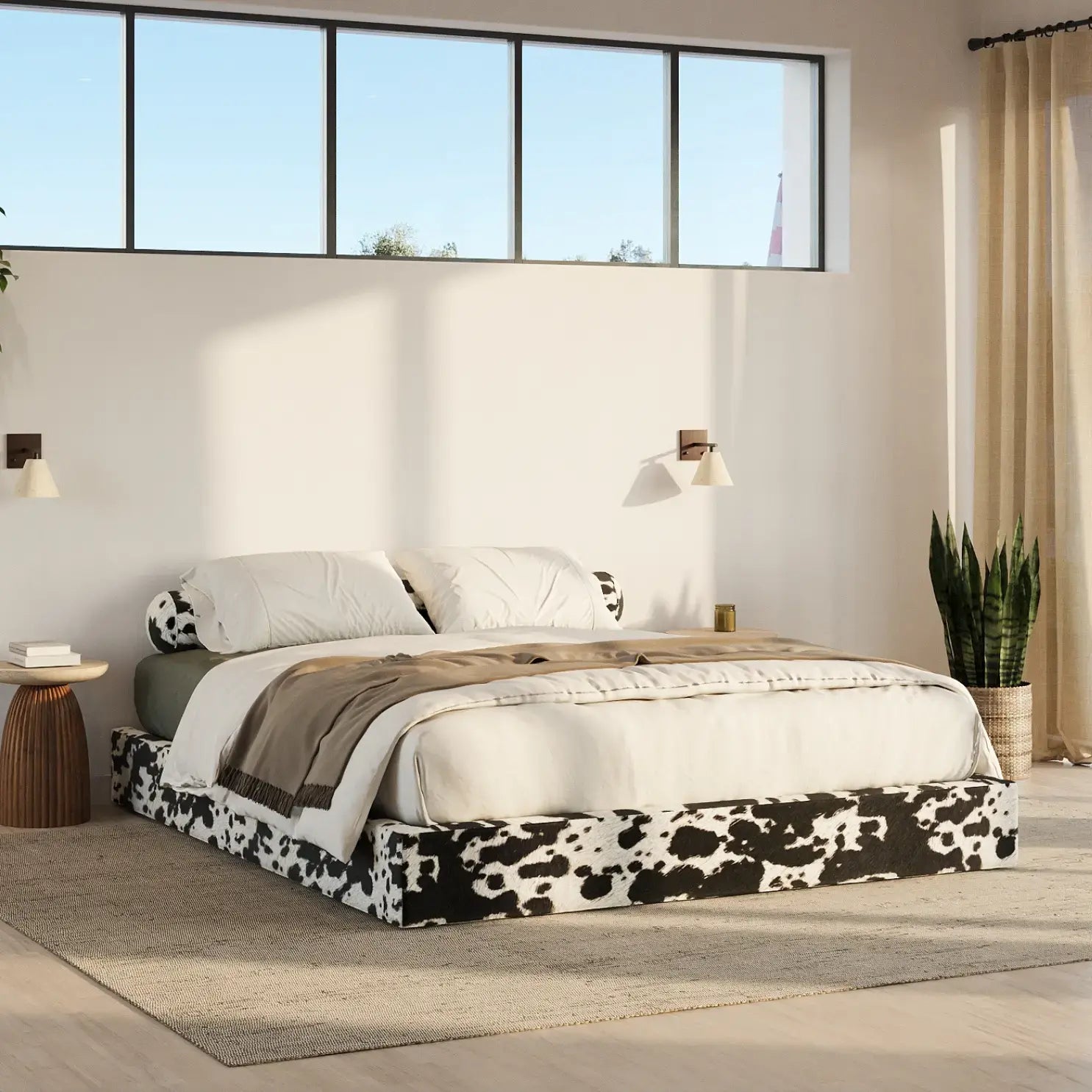 Modern bedroom with a bed featuring a cow print bed frame, white bedding, and decorative pillows | Classic Bed Frame in Vegan Cowhide | SoftFrame Designs