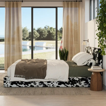Modern bedroom with cow print bed and large windows overlooking a pool and garden | Classic Bed Set in Vegan Cowhide | SoftFrame Designs