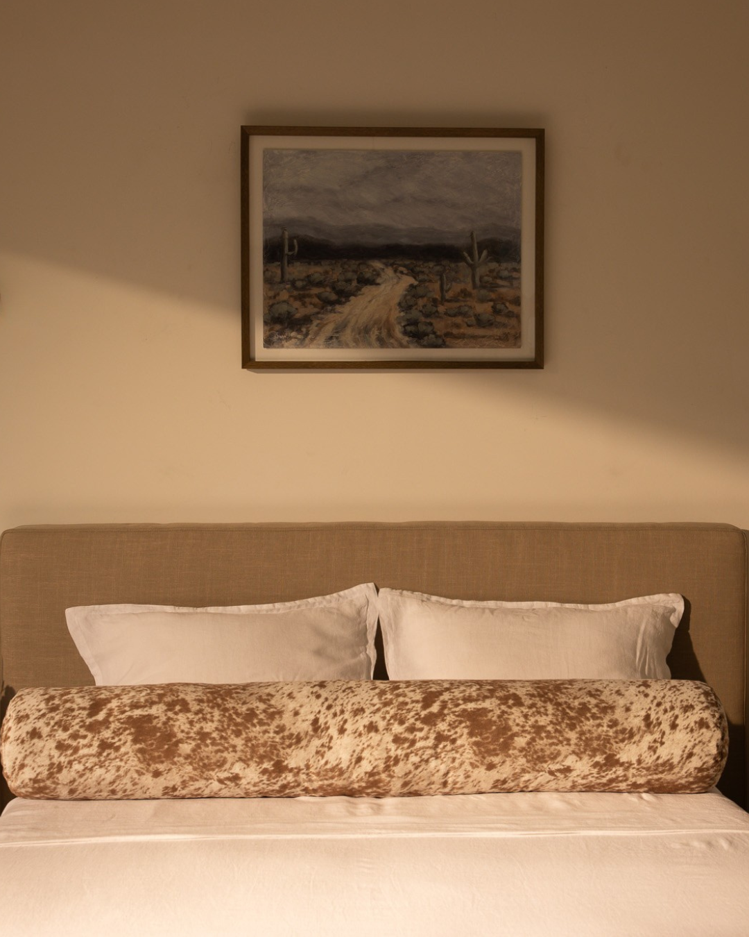 close up of bolster in vegan pony fabric on a bed