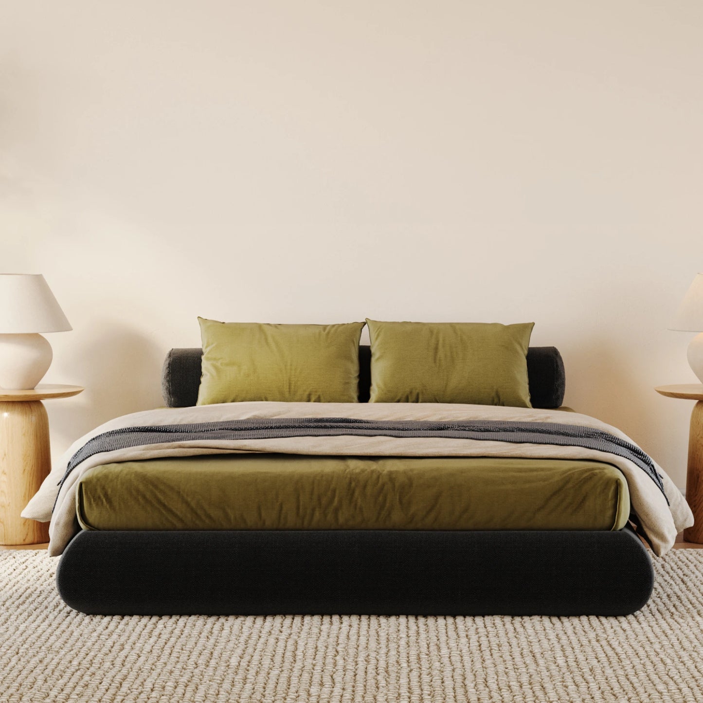All cushioned black bed frame with green sheets in a minimalistic bedroom