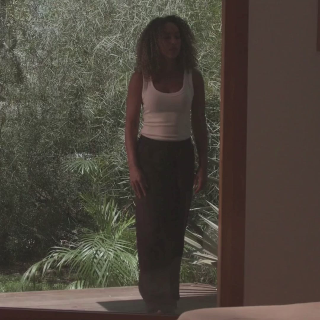 Girl walking into bedroom that has a soft bed frame in a tan fabric | Ultra Set, Queen, Sahara | SoftFrame Designs