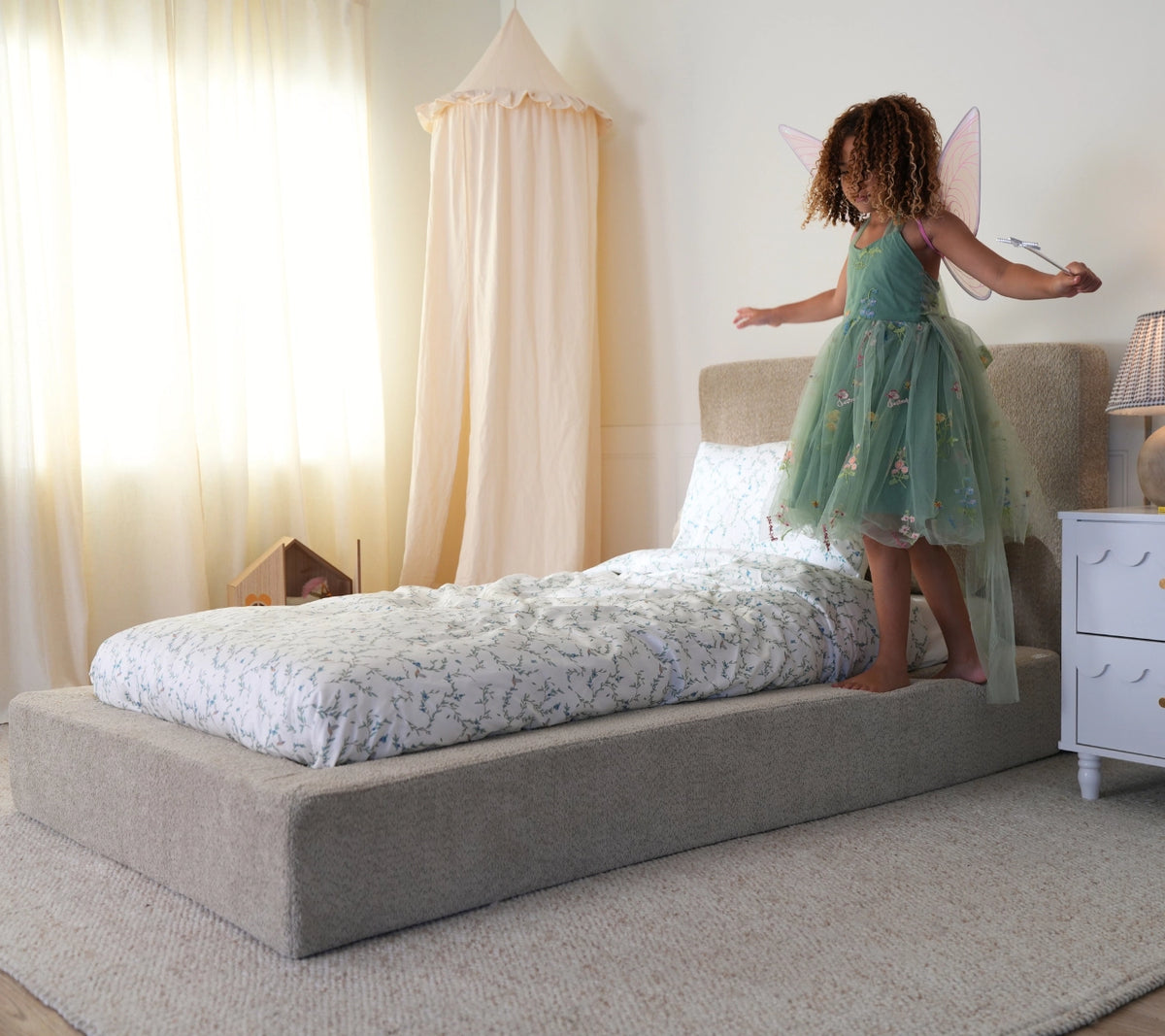 girl walking in the all cushioned bed frame from softframe designs in the fabric teddy